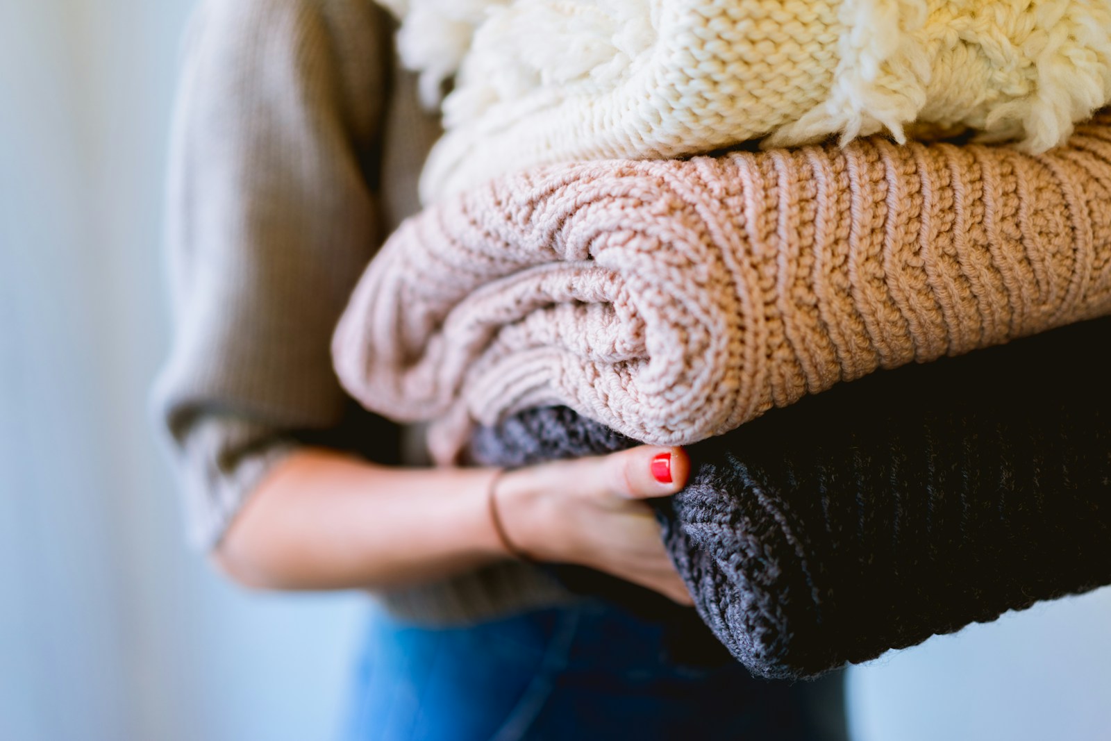 Photo by Dan Gold person holding knitted textiles